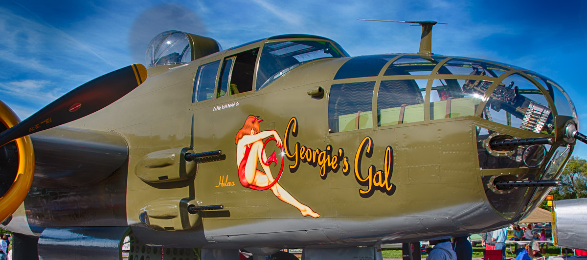 This is "Georgie's Gal" owned by Liberty Aviation Museum. She is a B-25 Bomber that was built in 1945. You can read more about her at http://warbirds-eaa.net/liberty-aviation-museums-b-25j-mitchell-wwii-bomber-georgies-gal/ and http://www.libertyaviationmuseum.org