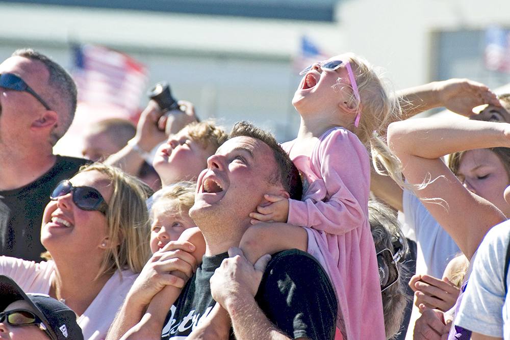 young girl sitting on man's shoulders